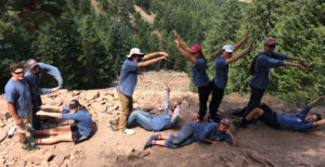 Boulder County Youth Corps - group people posing on a cliff