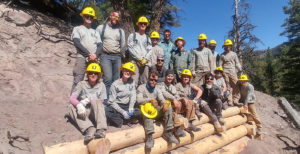 Southwest Corps members group shot among logs