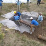 Sage Grouse Project - people lifting a log into a ditch